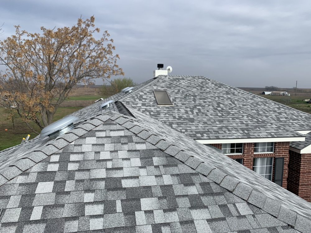 Completed light gray shingle roof replacement with skylights by FRS roofing company